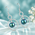 Teal Pearl Earrings on Light Teal Background